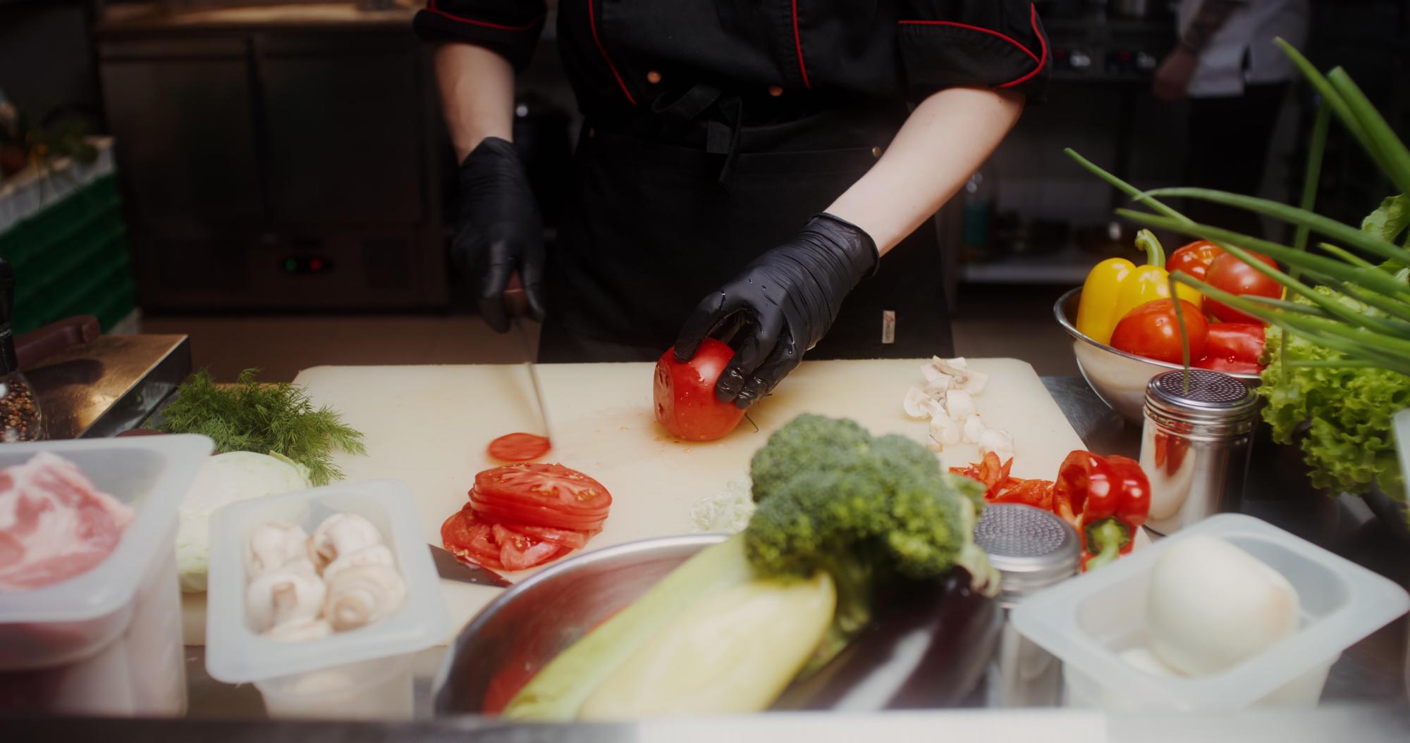 Workstation with chefs preparing plated dishes